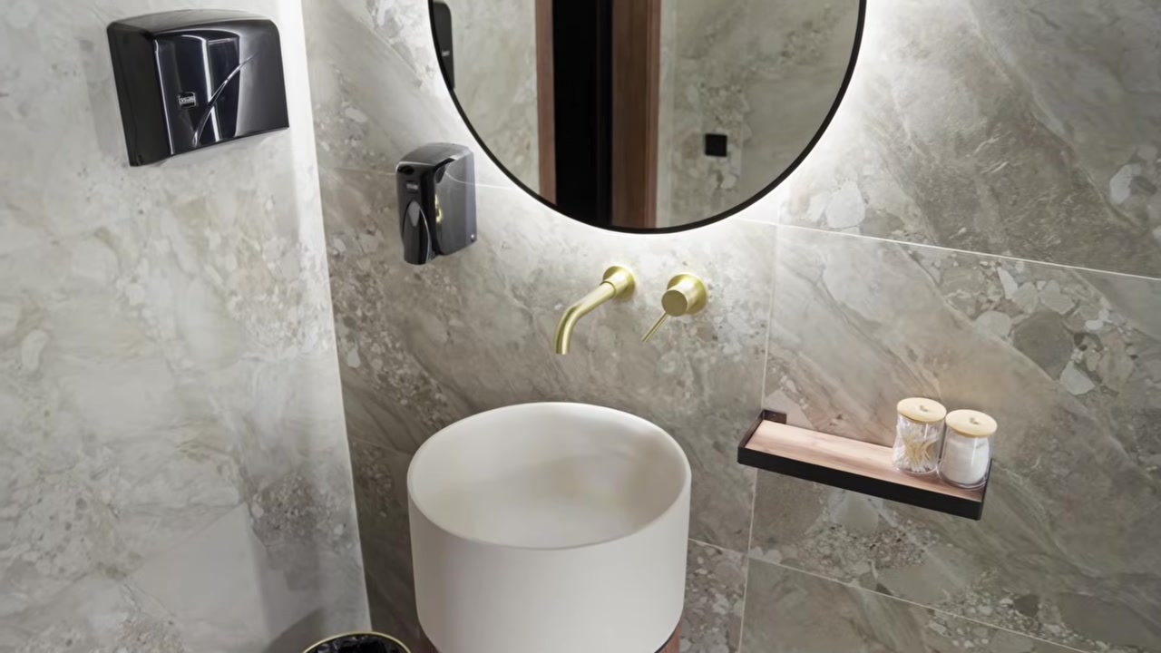 Bathroom with porcelain tile and a brass mixer